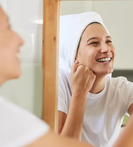 Woman looking at smile in mirror